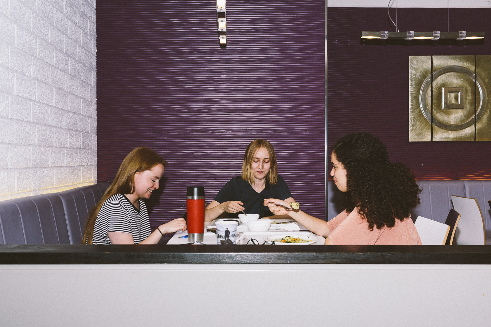 Drei Frauen essen am Tisch.